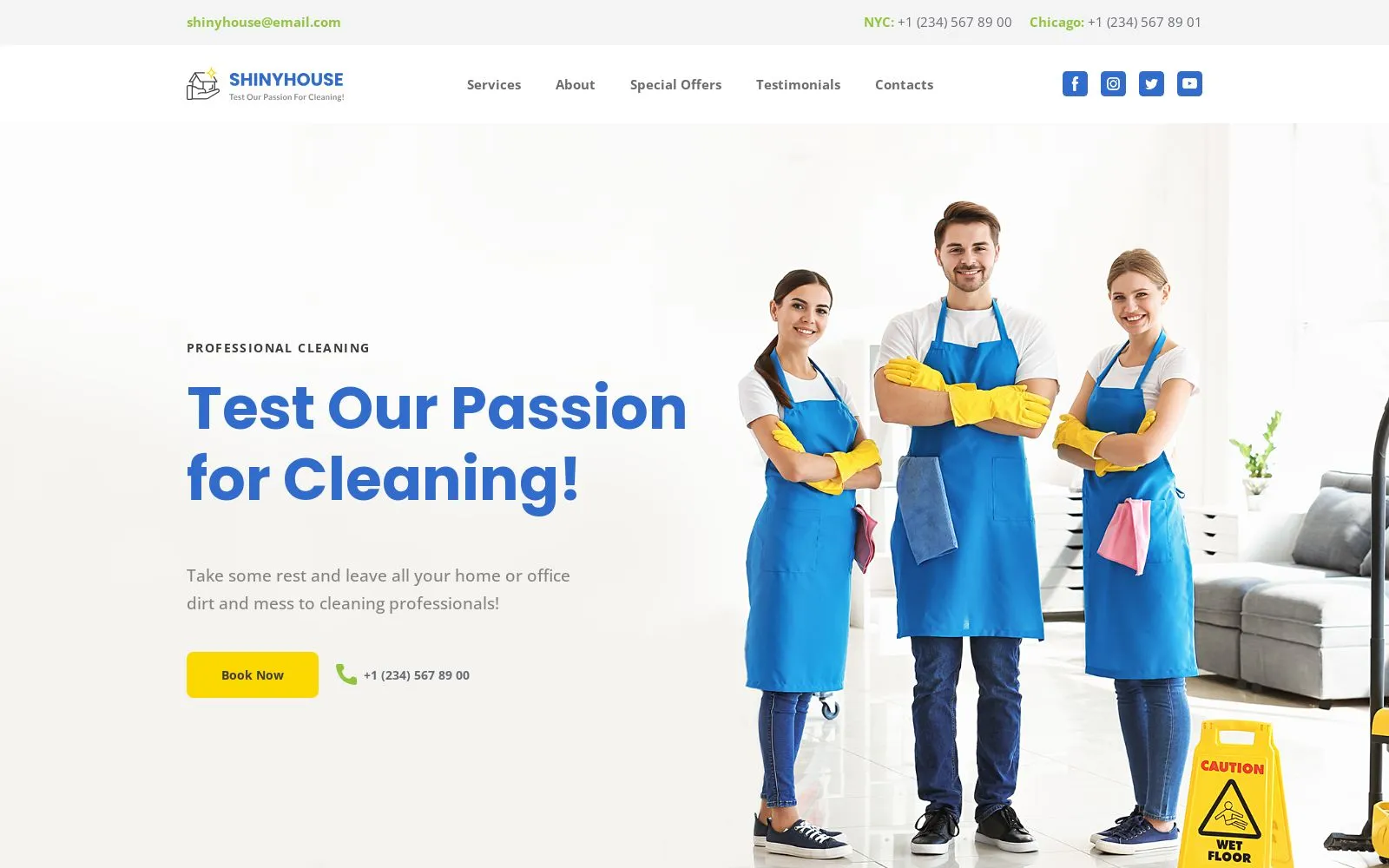 Team of cleaning professionals in blue aprons and yellow gloves, smiling and posing in a bright, modern interior, promoting home cleaning services with a caution sign indicating wet floor.