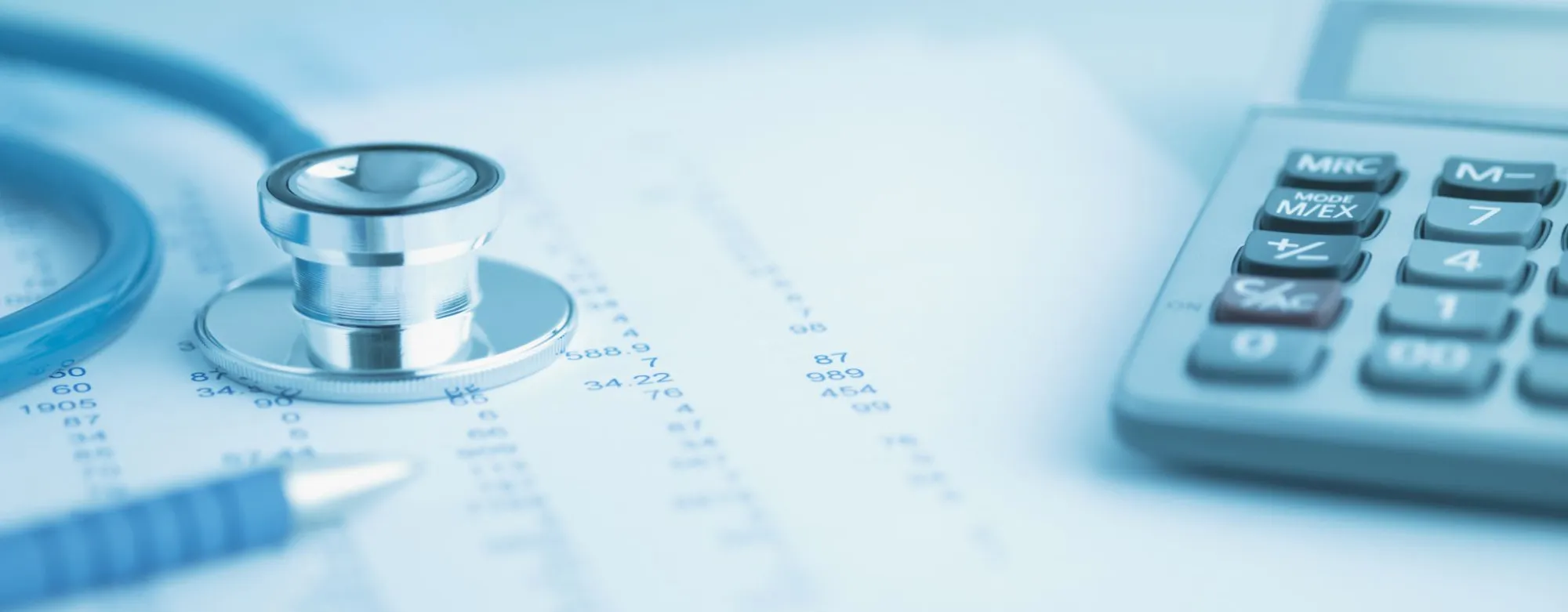 Stethoscope and calculator on medical paperwork, symbolizing digital solutions for healthcare organizations.