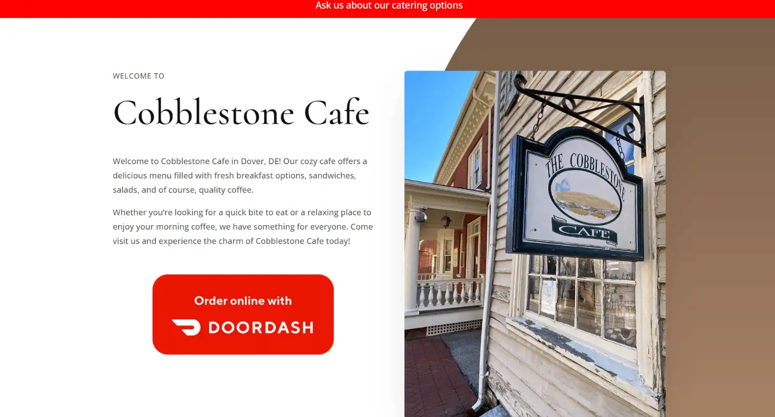 Cobblestone Cafe sign outside a charming cafe in Dover, DE, promoting breakfast, lunch, and coffee offerings, with a warm and inviting atmosphere.