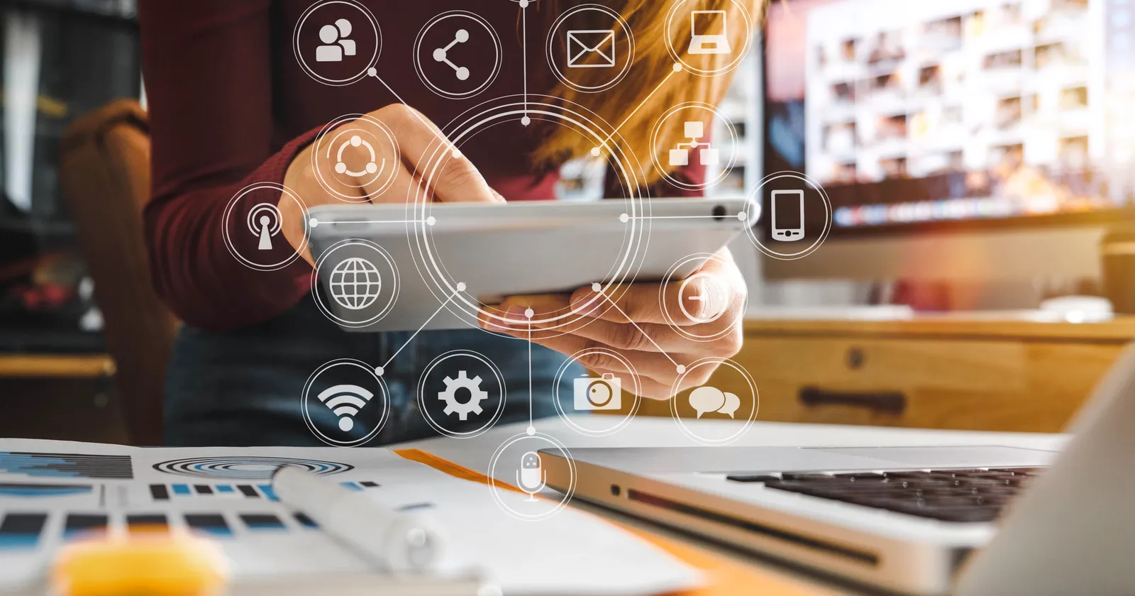 Person using a tablet with digital icons representing social media, communication, and connectivity, emphasizing link building and SEO strategies for website authority and rankings.