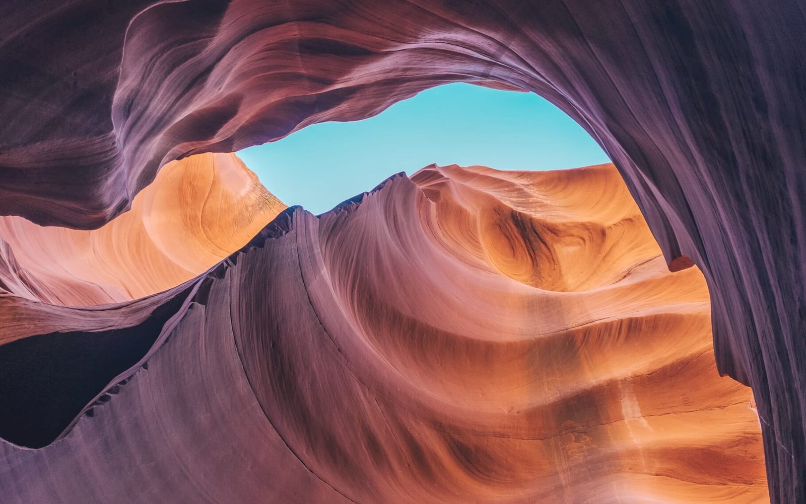 Colorful rock formations and blue sky viewed from inside a canyon, representing creativity and design possibilities for online business solutions.
