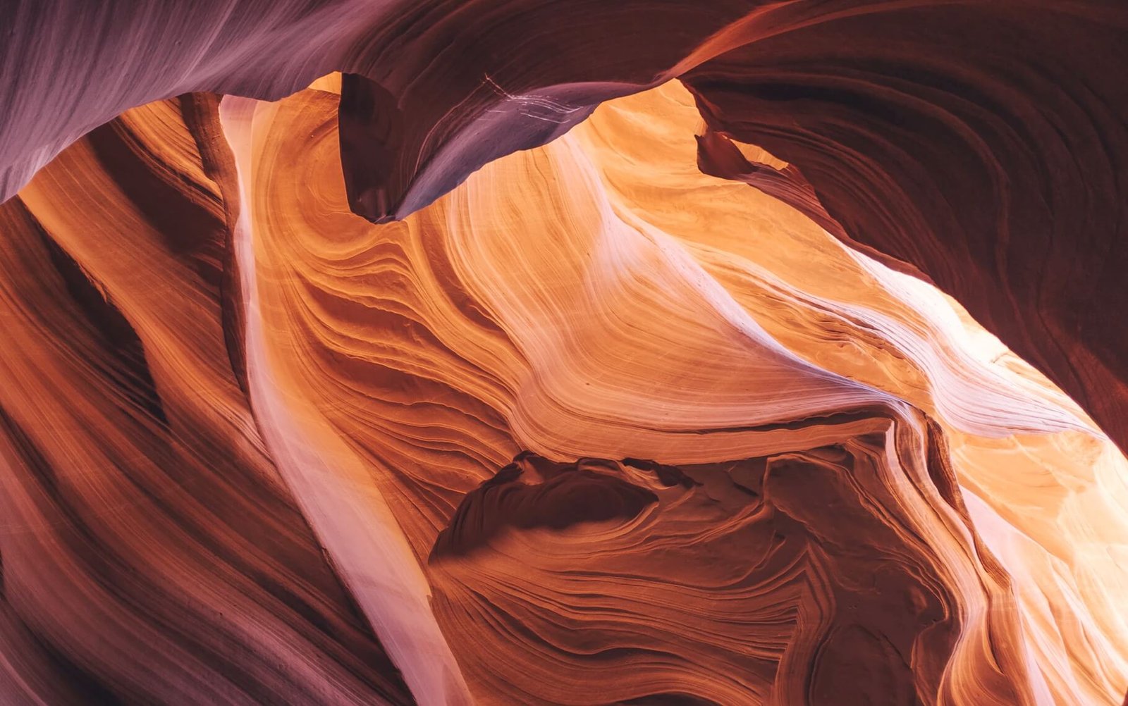 Abstract patterns of orange and cream sandstone formations in a canyon, illustrating natural beauty and creative design, relevant to web design and digital solutions.