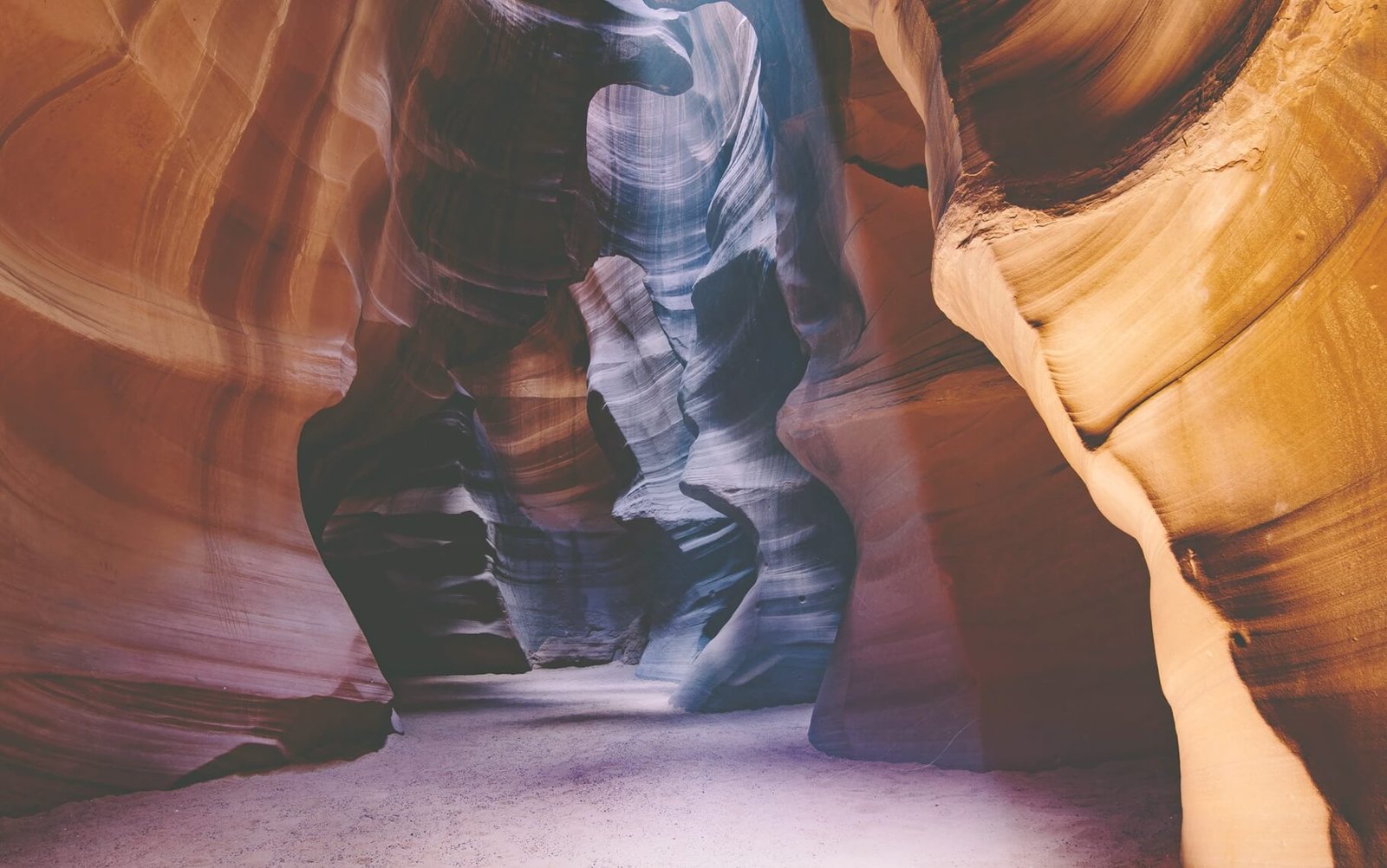Natural rock formations in Antelope Canyon showcasing smooth, layered textures and vibrant colors, emphasizing creative design and limitless possibilities in web aesthetics.