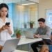 People using different devices in a modern office, emphasizing responsive web design
