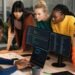 Diverse team analyzing cybersecurity data in a modern office, focusing on security audits for SMB growth.